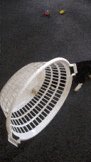 Pixie shoving the basket, which is now on it's side, and pushing it upright.